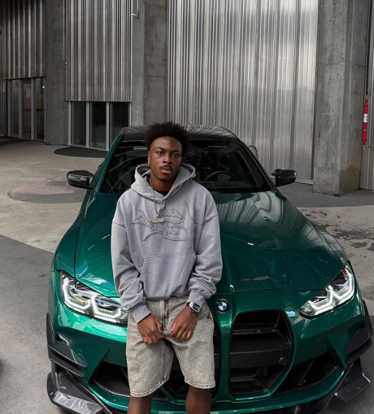 Kopressure standing in front of a green car